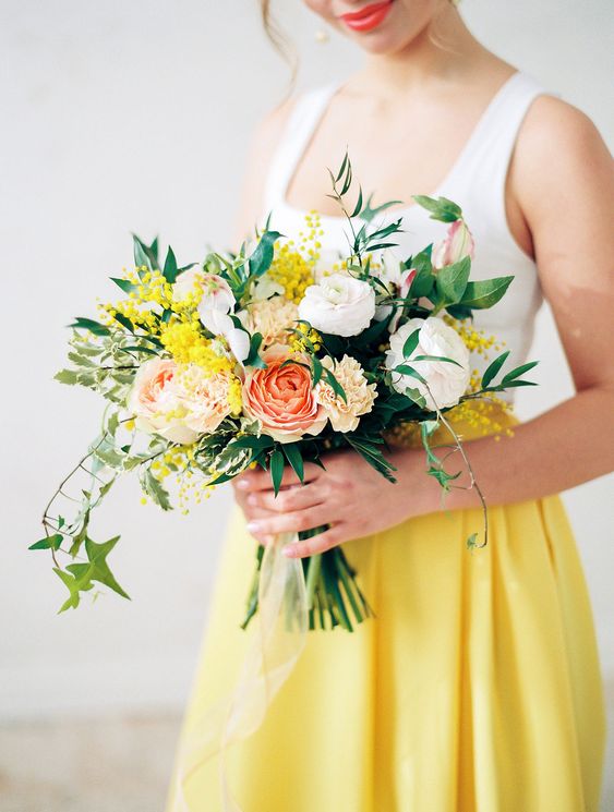 a bright spring wedding bouquet of white, coral and blush blooms, greenery and mimosa is a lovely idea for a spring wedding