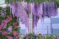 05 a bright flower-filled wedding ceremony space with pink, lilac, purple and blue flowers including wisteria and greenery