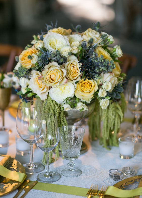 a summer wedding centerpiece of white rose sand peonies, thistles, berries and amaranthus is a cool idea for a garden wedding
