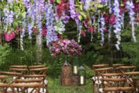 07 a bright wedding ceremony space with a bold and lush arrangement and wisteria and roses plus greenery hanging down is a unique blooming space