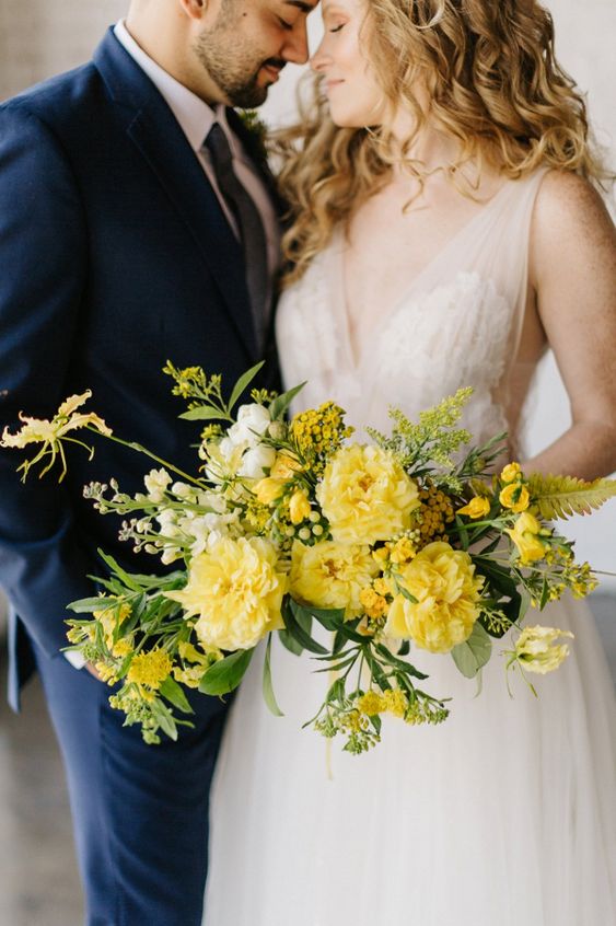 a chic yellow wedding bouquet of various blooms including mimosa as a filler is amazing for spring and summer