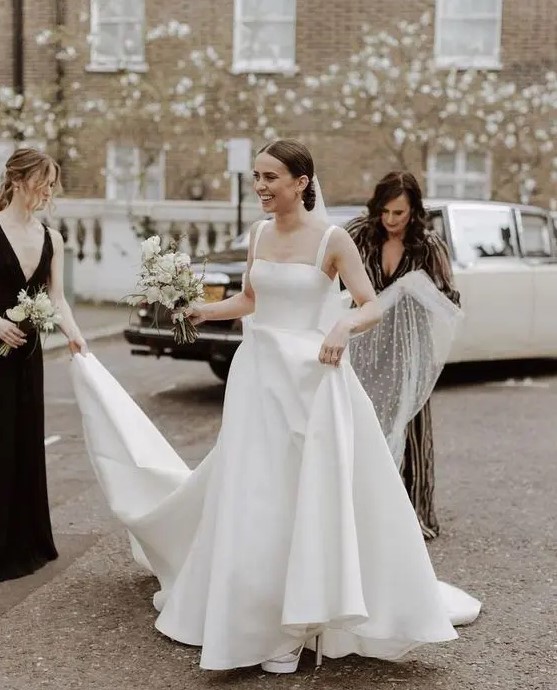 a refined modern wedding ballgown with a square neckline and thick straps plus a long train just wows