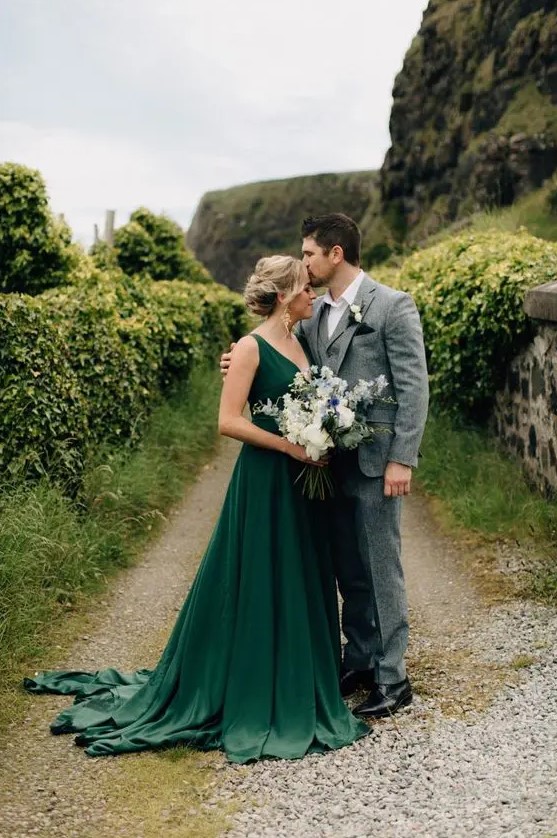 a simple and stylish green A-line wedding dress with thick straps, a deep neckline and a train makes a statement