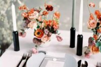 11 a bold minimalist wedding tablescape with neutral linens, a grey plate, black candleholders and neutral candles and bright blooms