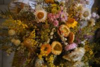 13 a lush dried flower wedding bouquet with mimosa, leaves and various blooms is a gorgeous idea for a wedding