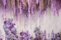14 a gorgeous and lush wedding backdrop with wisteria hanging down and an altar of purple, violet and lilac blooms and greenery
