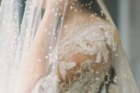 15 a bold pearly veil paired with a beaded dress for a super glam and formal wedding