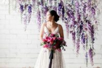 15 a gorgeous indoor wedding backdrop composed of hanging blooms and colorful dried leaves including wisteria is an amazing idea