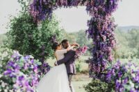 16 a jaw-dropping wedding arch covered with greenery and wisteria and matching arrangements look jaw-dropping