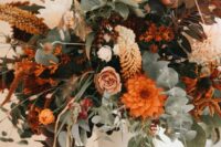 17 a bright fall wedding centerpiece with a white vintage urn, greenery, lots of blooms in orange, blush, rust and coffee shades