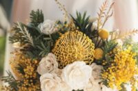 17 a lush wedding bouquet of white roses, a pincushion protea, mimosa, greenery and billy balls is amazing for spring or summer