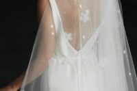 19 a modern plain wedding dress paired with a wedding veil embellished with smaller and bigger fabric flowers and beads
