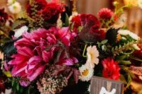 22 a dark pink and bold red lush floral centerpiece with grapes is a gorgeous decadent wedding centerpiece