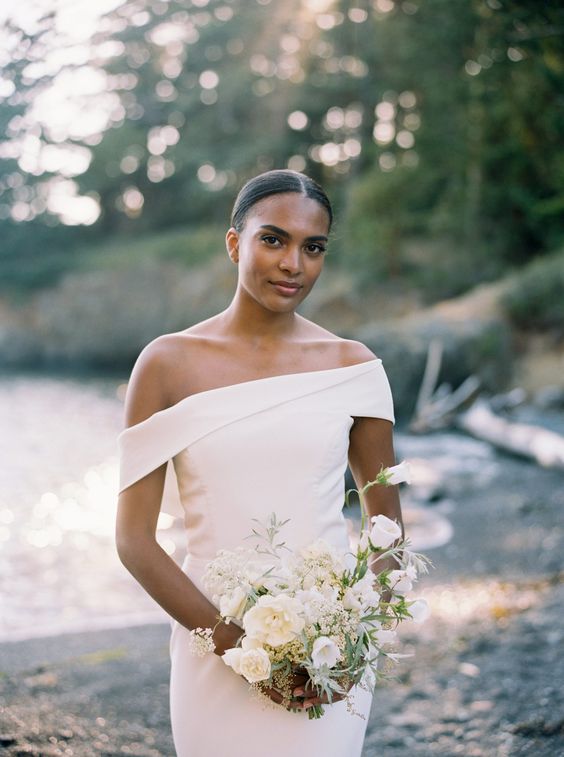 a modern off the shoulder plain wedding dress with an asymmetrical neckline is a lovely idea for a modern or minimalist bride