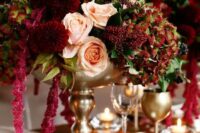 23 a decadent wedding centerpiece of blush roses, burgundy mumes, berries, greenery and amaranthus is a very refined solution