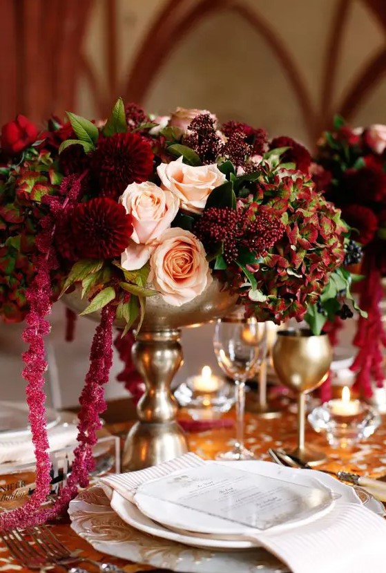 a decadent wedding centerpiece of blush roses, burgundy mumes, berries, greenery and amaranthus is a very refined solution