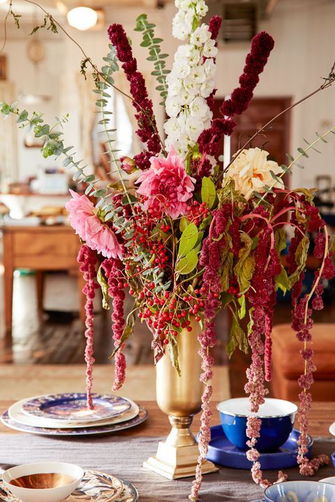 a bold wedding centerpiece of pink and white dahlias, blooming branches, amaranthus and berries for the fall