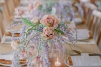 26 a chic and refined wedding centerpiece of wisteria and peachy blooms is a cool idea for a relaxed spring wedding