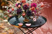 26 a gorgeous decandent wedding centerpiece with pink, orange, dark plum and blush blooms and textural greenery and branches