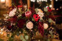 27 a bold wedding centerpiece of blush roses, red anemones, king proteas, greenery and amaranthus is a very chic idea for the fall