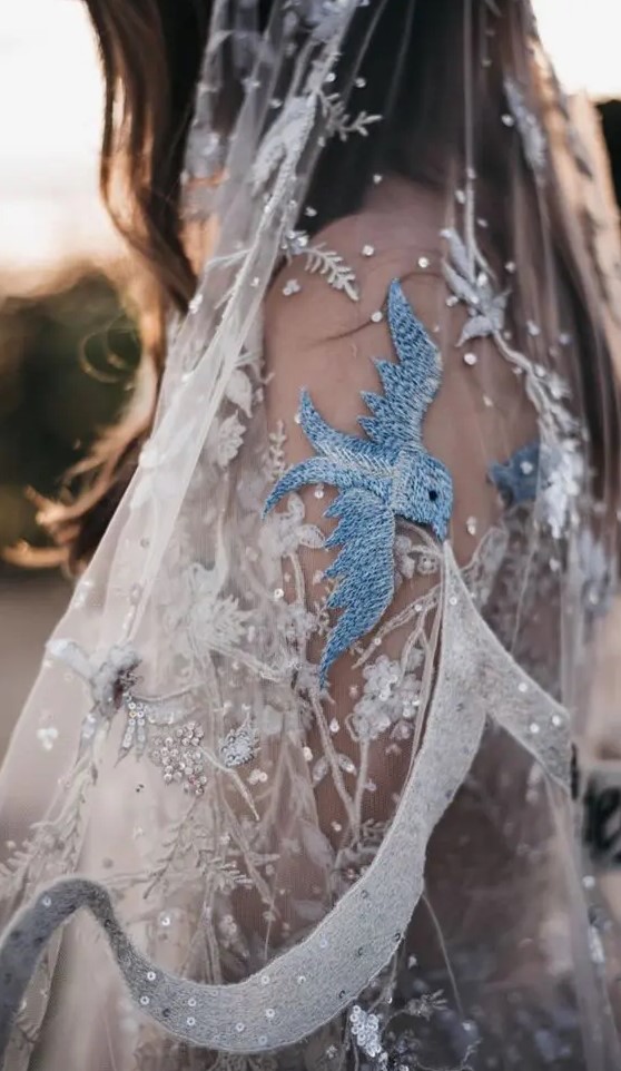 a beautiful embroidered and embellished wedding veil with crystals, sequins and blue birds is amazing for a wedding