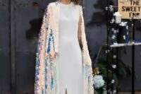 30 a bold modern bride wearing a minimalist white plain wedding dress with a slit and an iridescent coverup with a train