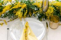 30 a bright and lively wedding tablescape with a mimosa runner, white porcelain and yellow napkins plus grey glasses