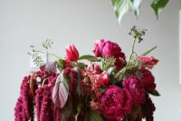30 a vibrant wedding centerpiece of pink peonies, amaranthus, greenery and dark foliage is a chic and cool idea for summer or fall