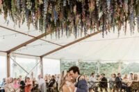 31 a dreamy wedding dancing floor with greenery, wisteria and some other blooms hanging down is a lovely idea