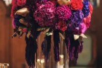 31 a fantastic lush wedding centerpiece of purple, violet, fuchsia, orange blooms and gilded pears and pomegranates is wow