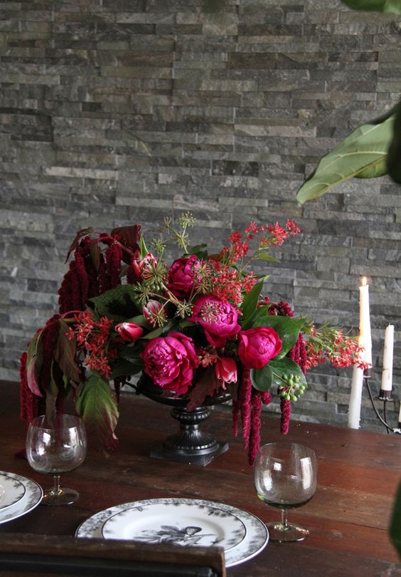 a chic fall wedding centerpiece of pink peonies, amaranthus, greenery, berries and foliage is amazing for the fall