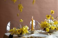 34 a fine art wedding tablescape with a grey tablecloth and napkins, yellow centerpieces with mimosa and some mimosa over the table