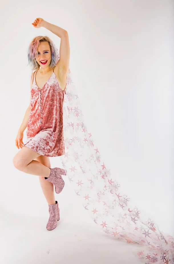 a rock n roll bride wearing a pink velvet dress, pink glitter boots and a pink and purple star veil as a bold accessory