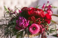 35 a bold wedding centerpiece of red and pink peonies, anemones, greenery, berries and amaranthus is amazing