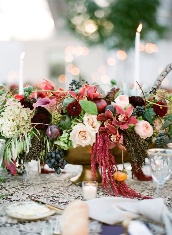 a bold fall wedding centerpiece of blush roses and peony roses, dahlias, mums, callas, amaranthus, greeneyr, grapes and hydrangeas
