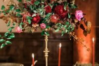 37 a very elegant fall wedding centerpiece of burgundy and pink blooms, berries and greenery on a tall stand