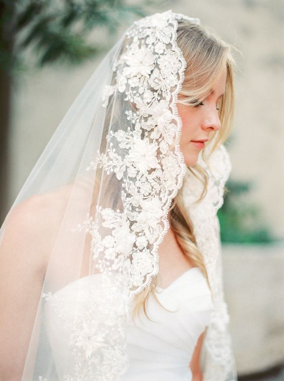 a beautiful lace mantilla veil with floral applique is a refined and chic idea for a refined bride