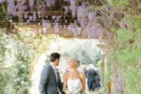 38 a lovely wedding walkway covered with wisteria, with greenery and blooms all over, is a chic and Instagrammable location