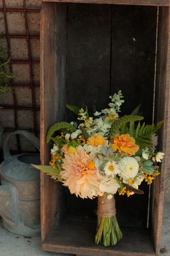 a bold orange wedding bouquet of mums, dahlias and marigolds plus some matchines fillers and greenery is a cool idea for a fall rustic bride