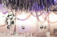 39 a lush oversized wedding chandelier with wisteria and greenery hanging down is a gorgeous decoration for a refined wedding