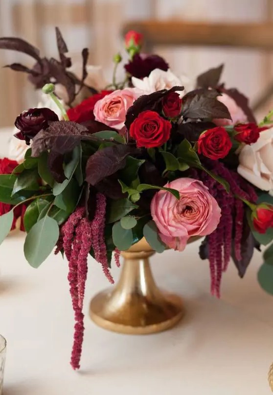 an elegant wedding centerpiece of white, pink and red roses, greenery and dark foliage, amaranthus is a super cool and chic idea