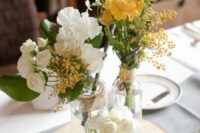 41 a rustic cluster wedding centerpiece of a tree slice, white and yellow roses, mimosa, greenery is a lovely and romantic idea