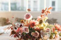 42 a beautiful and bright wedding centerpiece of rust, dusty pink and coral blooms, bold fall leaves is a very refined idea
