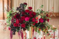 43 a vibrant fall wedding centerpiece of red and blush roses, burgundy dahlias, dark foliage and greenery and amaranthus