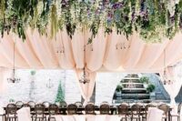 44 a refined and beautiful wedding reception space with blush curtains, greenery and wisteria is a lovely idea for a chic wedding