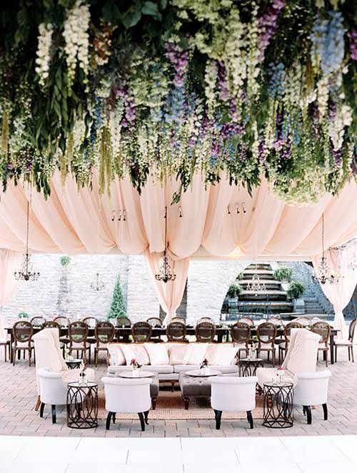 a refined and beautiful wedding reception space with blush curtains, greenery and wisteria is a lovely idea for a chic wedding