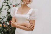 44 an elegant wedding dress with a square neckline and sheer puff sleeves for a feminine and chic look and flower earrings that accent the look
