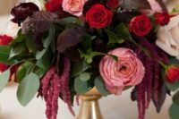 45 an elegant wedding centerpiece of white, pink and red roses, greenery and dark foliage, amaranthus is a super cool and chic idea