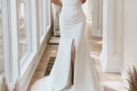 45 an ultra-modern plain fitting wedding dress with a high neckline, short sleeves, a front slit and a train for a minimalist bride