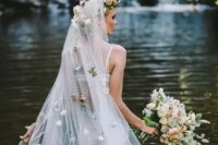 46 a long veil with a faux flower halo on top and pastel-colored faux blooms all over the veil